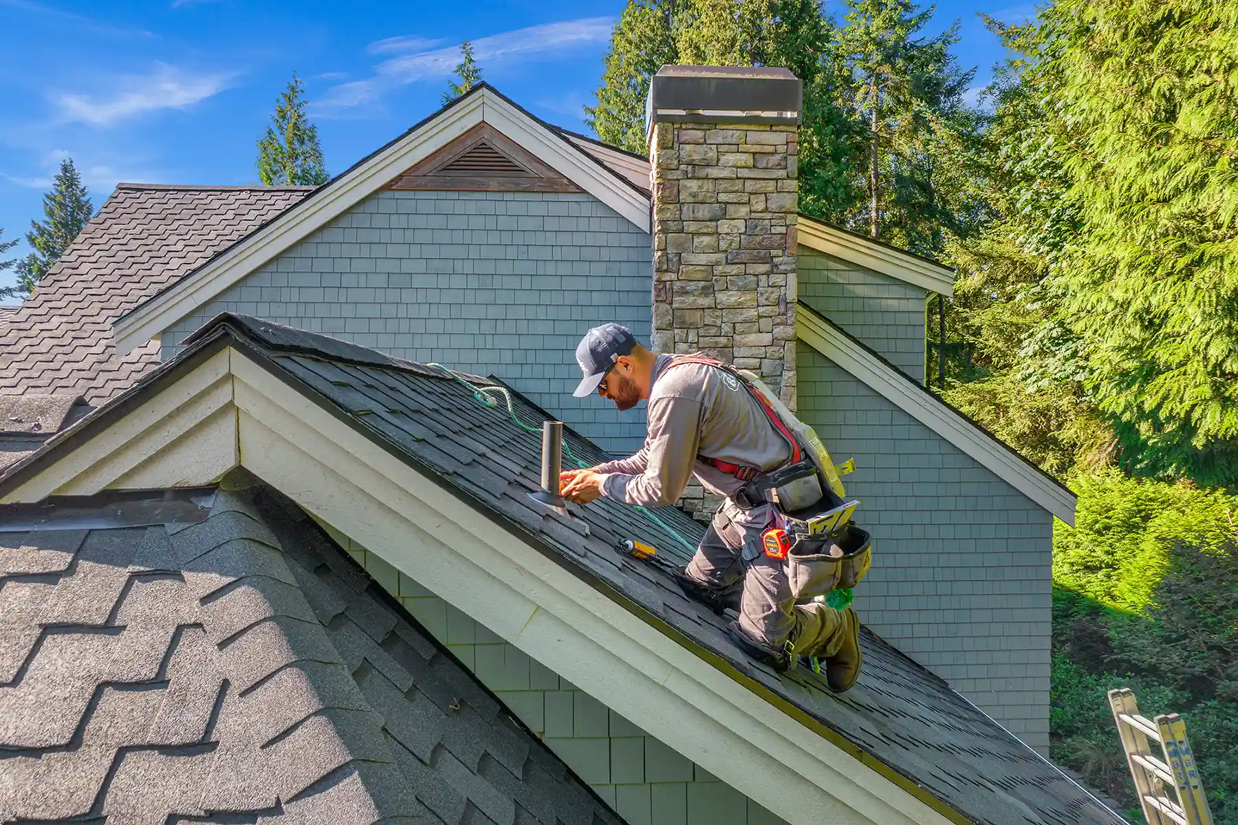 MVP roofer on sloped asphalt roof.